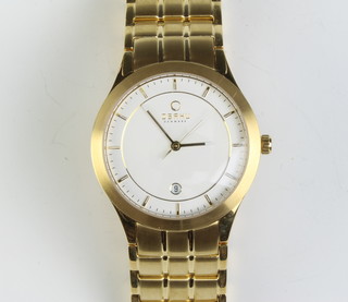 A gentleman's gilt cased Obaku calendar wristwatch on a gilt bracelet boxed 