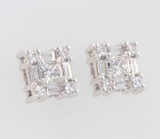 A pair of 18ct white gold brilliant and baguette cut diamond ear studs