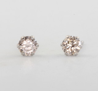 A pair of platinum and diamond ear studs, approx. 0.3ct 