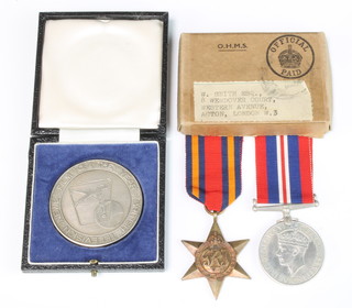 A silver medallion "British Television News Film of The Year 1967 to Paul Newitt, first award hard news (team) 1967" together with 2 World War Two medals to W Smith comprising Burma Star and War medal in posting box 
