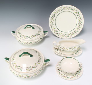 A Royal Doulton Almond Willow D6373 dinner service comprising 22 small plates, 30 dinner plates, 4 meat plates, serving plate, a bowl, 20 soup bowls, 4 sauce boats, 4 stands, 10 two handled bowls, 5 tureens and 4 covers, 4 dessert bowls and 11 tea plates