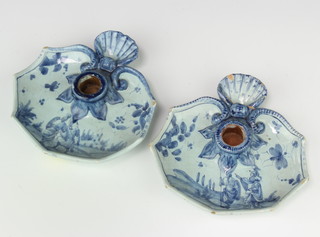 A pair of Continental blue and white candle holders with leaf shaped bodies and shell handles decorated with warriors 17cm 
