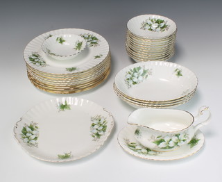 A Royal Albert Trillium coffee, tea and dinner service comprising 11 dinner plates, 12 soup bowls, sauce boat and stand, 4 serving bowls, sandwich plate, dish, 6 coffee cups (1af), 10 saucers,  8 tea cups, 10 saucers, teapot, 2 milk jugs, 2 cream jugs, sugar bowl, slop bowl, 9 tea plates, 1 small plate and 4 side plates 