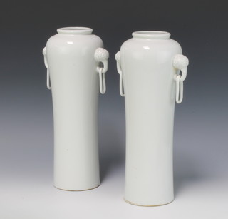 A pair of Chinese oviform blanc de chine vases with elongated lion ring handles 35cm 
