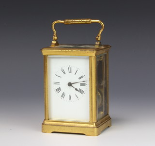 A French striking carriage timepiece with enamelled dial and Roman numerals contained in a gilt metal case 13cm x 8.5cm x 7cm