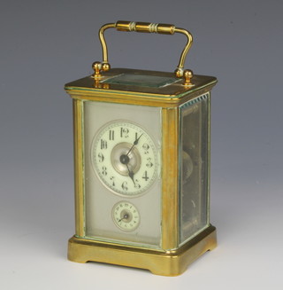 A 19th Century French 8 day striking carriage alarm clock with silvered dial, enamelled chapter ring and Arabic numerals, contained in a gilt metal case 
