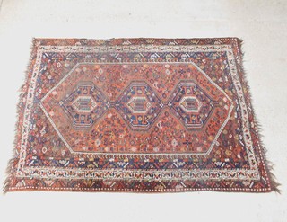 An Afghan rug with 3 diamond shaped medallions to the centre within a multi row border 282cm x 212cm, in wear 