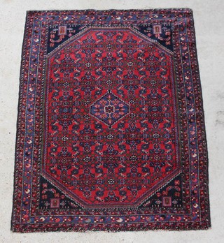 A red and blue ground Persian rug with diamond medallion to the centre 195cm x 150cm 