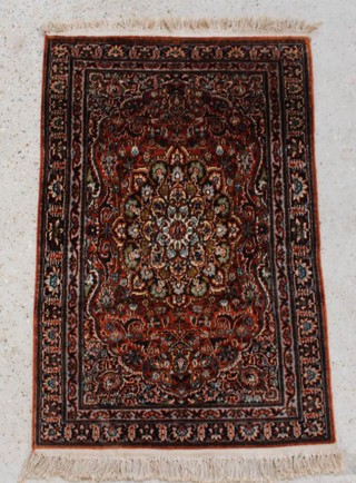 A Persian silk rug with central floral medallion 120cm x 78cm 
