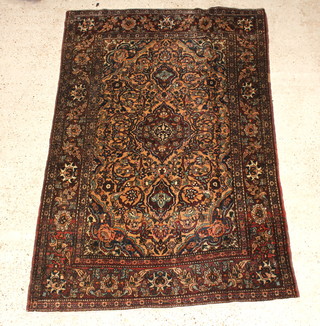 A brown and blue ground Persian Isfahan rug 205cm x 140cm 