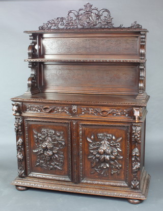 A Victorian carved oak dresser/cabinet, the raised and pierced back fitted 2 shelves above 2 long drawers and a cupboard enclosed by panelled doors with carved fruit decoration 198cm h x 137cm w x 54cm d 