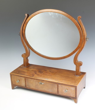 An oval Georgian mahogany dressing table mirror contained in an inlaid mahogany frame, the base fitted 1 long and 2 short drawers raised on  bracket feet 55cm x 50cm x 20cm 