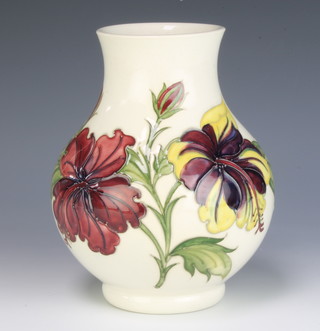 A Moorcroft cream ground baluster vase decorated with hibiscus impressed and signature marks 20cm 