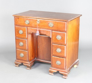 A Georgian mahogany kneehole dressing table fitted 1 long drawer above a secret drawer, the pedestal fitted a cupboard enclosed by panelled door and having 6 short drawers, raised on ogee bracket feet 78cm h x 86cm w x 47cm d 