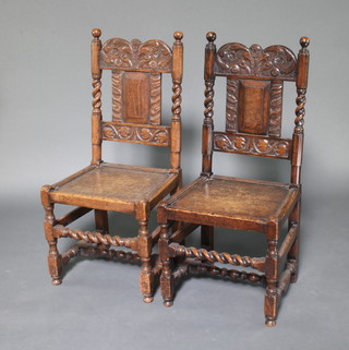 A pair of Victorian carved oak 17th Century style hall chairs with solid seats and backs, spiral turned and block supports 