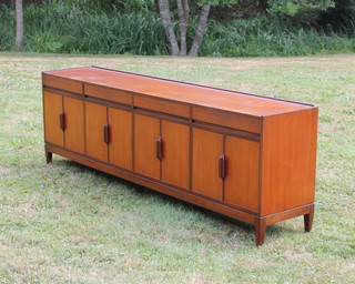 Robert Heritage for Archie Schine, a 1960's teak sideboard fitted 4 drawers above 4 cupboards enclosed by panelled doors, raised on wedge shaped supports 79cm h x 238cm w x 45cm d  
