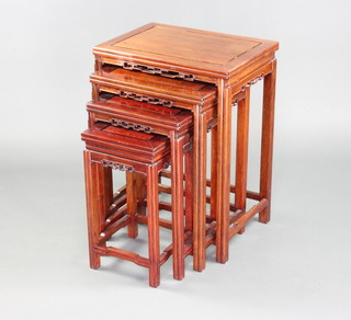 A nest of 4 Chinese rectangular Padauk interfitting coffee tables with carved and pierced aprons, 70cm h x 51cm w x 37cm d, 62cm x 43cm x 33cm (ring mark to the top), 56cm x 35cm x 30cm and 49cm x 27cm x 27cm 