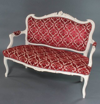 A French style white painted show frame salon settee with red sculpted upholstery raised on cabriole supports 96cm x 122cm x 57cm 
