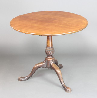 A Georgian circular mahogany tea table raised on a turned column and tripod base 69cm h x 82cm diam. 
