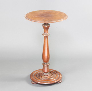 A Victorian circular mahogany wine table raised on a turned column, circular base, bun feet 67cm h x 41cm diam. 