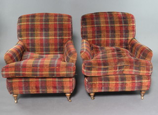 A pair of Howard style armchairs upholstered in tartan pattern material 