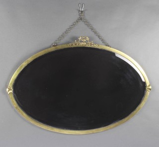 A 1920's oval bevelled plate wall mirror contained in a gilt frame surmounted by an urn 80cm x 54cm 