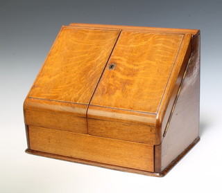 A Victorian light oak wedge shaped stationery box, having a stepped interior fitted a perpetual calendar and with secret drawer to the base 30cm h x 39cm w x 27cm d 