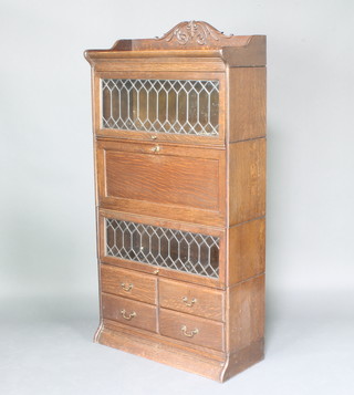 An oak Globe Wernicke style 4 tier bureau bookcase, the upper section with 3/4 gallery enclosed by a lead glazed panelled door, above a secretaire with fall front and a bookcase enclosed by lead glazed panelled doors, the base fitted 4 short drawers with brass swan neck drop  handles 174 cm h x 87cm w x 36cm d  