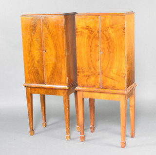 An Art Deco walnut cigar cabinet, the cedar lined interior fitted 8 drawers with turned ivory handles enclosed by a pair of quarter veneered panelled doors, the base fitted 1 long drawer, raised on square tapered supports with splayed feet, together with a matching cabinet 122cm h x 146cm w x 32cm d