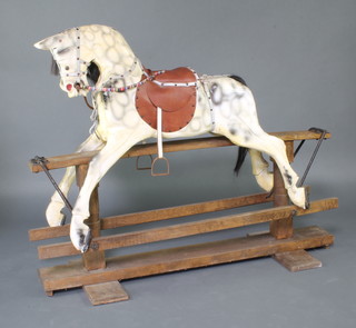 A wooden painted dapple grey rocking horse 106cm h x 133cm w x 45cm d 