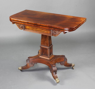 A Regency mahogany D shaped card table, raised on a square column with triform base and splayed feet ending in brass paw casters 75cm h x 91cm w x 45cm d 
