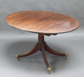 A Georgian style mahogany extending dining table raised on a gun barrel and tripod base 77cm h x 136cm l x 99cm w