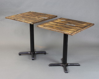 A pair of iron and weathered pine square pedestal restaurant tables raised on circular columns. Only one table has adjustable feet 80cm h x 68cm w x 70cm d 