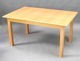 A light oak extending dining table raised on square tapered supports with 1 extra leaf 74cm h x 146cm l x 95cm w 