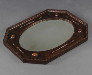 A 1930's Jacobean style oval bevelled plate wall mirror contained in a lozenge shaped frame with geometric mouldings 67cm x 51cm 