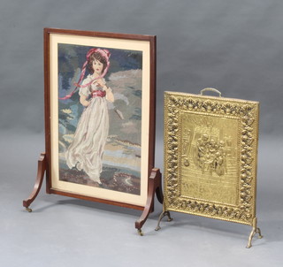 An Edwardian mahogany fire screen with Berlin wool work panel of a Gainsborough Lady 82cm h x 55cm w x 36cm d together with an embossed brass fire screen with tavern scene 59cm x 41cm 
