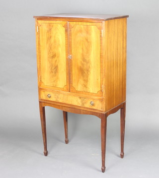 A Georgian style mahogany cocktail cabinet fitted a cupboard enclosed by panelled doors above 1 long drawer, raised on square supports, spade feet 130cm h x 70cm w x 41cm d 
