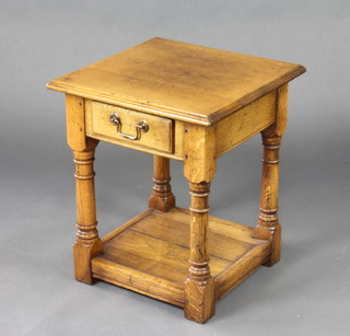 A square light oak 2 tier occasional table with frieze drawer, raised on turned and block supports 53cm h x 45cm w x 46cm d 