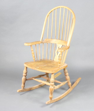 A Windsor style beech framed hoop back rocking chair 