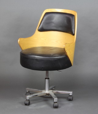 An Eames style chrome and plywood tub back revolving office/desk chair with black leather upholstered seat and panel to the back 