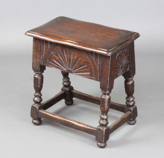 A rectangular carved oak stool box with hinged lid and carved apron, raised on turned and block supports 46cm h x 46cm w x  27cm d 