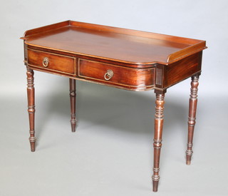 A 19th Century mahogany side table with raised back, the base fitted 2 long drawers raised on ring turned supports 79cm h x 102cm w x 57cm d 