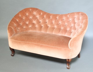 An Edwardian mahogany shaped twin seat sofa upholstered in buttoned rose pink material and raised on cabriole supports 79cm h x 139cm w x 76cm d  