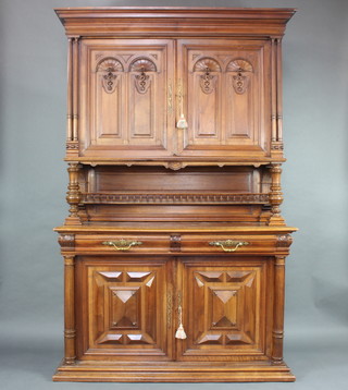 A 19th Century French carved walnut dresser, the upper section enclosed by panelled doors above a shelf, the base fitted 2 drawers above a cupboard enclosed by panelled doors 230cm h x 144cm w x 59cm d 