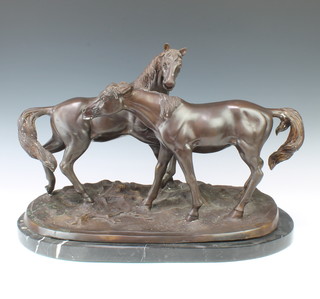 A bronze figure of 2 standing horses, raised on an oval naturalistic base and with black veined marble base 41cm h x 59cm w x 32cm 