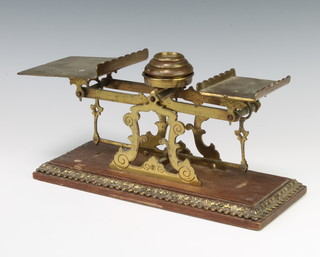 A pair of Victorian brass letter scales raised on a rectangular oak base with gilt metal mounts complete with weights 13cm x 30cm x 12cm 