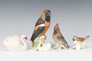 A Goebel figure of a Hawfinch 15cm, a do. of a Chaffinch 10cm, a do. finch 5cm and a swan 5cm 