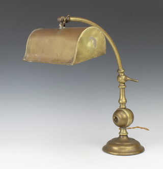 An adjustable brass bank light raised on a circular base 40cm h x 13cm diam. 