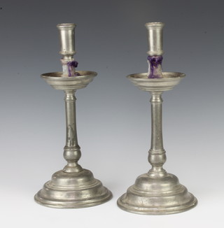 A pair of Continental pewter candlesticks, the bases marked SS Cosma ET Damianus 1677, the base with 4 touch marks 32cm x 14cm 