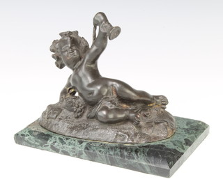 A bronze figure of a reclining inebriated cherub raised upon a green marble base 12cm x 18cm x 12cm 